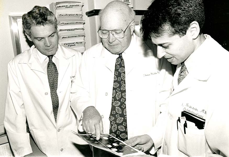 Dr. Thomas O. Muldoon and 2 other doctors consult
