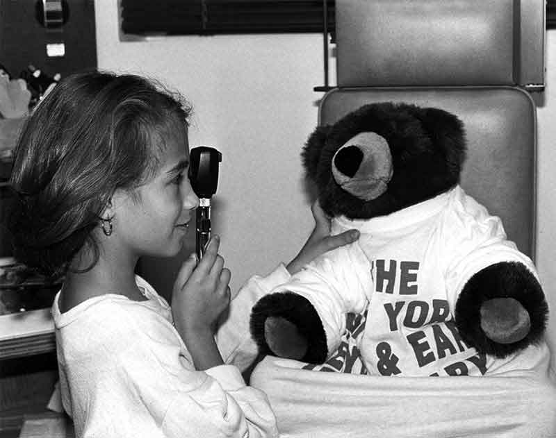 Girl and teddy bear in exam room